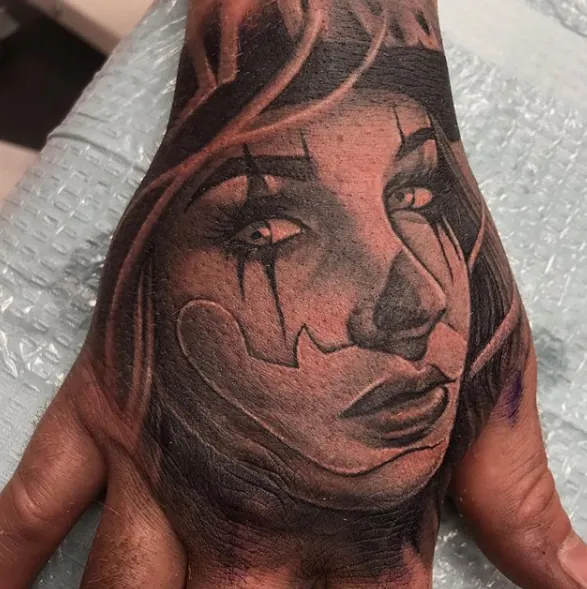 Portrait tattoo of a woman's face on a hand by Moose, Calgary Tattoo Company